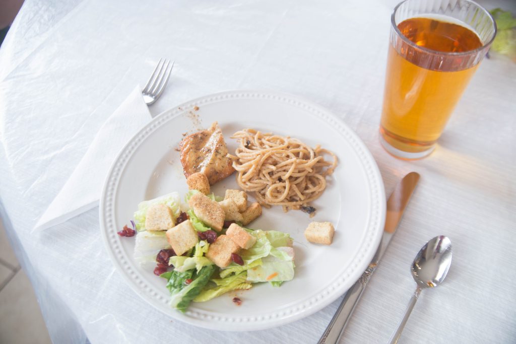 Plate fixed with chicken, pasta, and salad from Raddish Kids recipes.